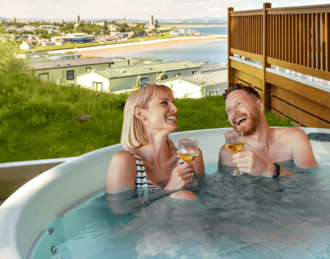 Couple enjoying wine in a hottub