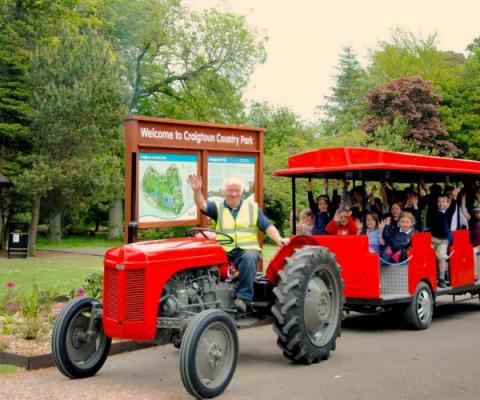 Tractor towing passengers on trailer