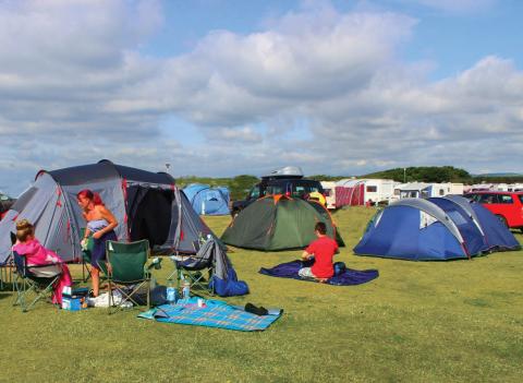 Family by tents at Elie Holiday Park