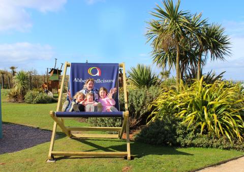 Guests enjoying the giant deckchair at Elie Holiday Park
