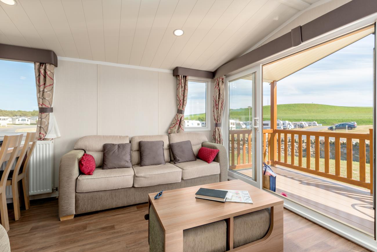 Light and airy lounge with open patio doors leading onto sunny veranda