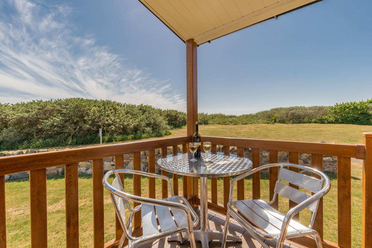 Open bottle of wine on patio table on sunny veranda