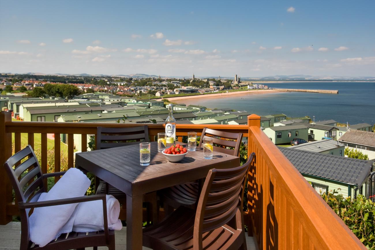 Open bottle of wine on patio table on sunny veranda