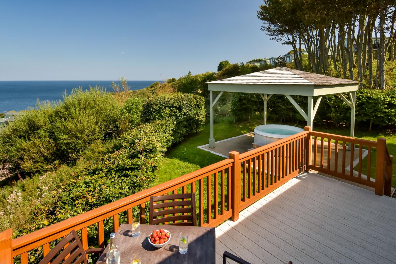 lodge with hot tub and sea views in dabbled sunlight