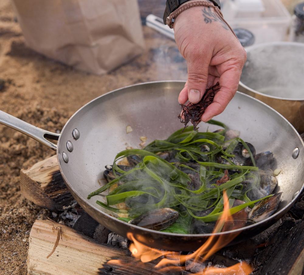 Jayson Byles from East Neuk Seaweed wild cooks kelp tagliatelle on the beach