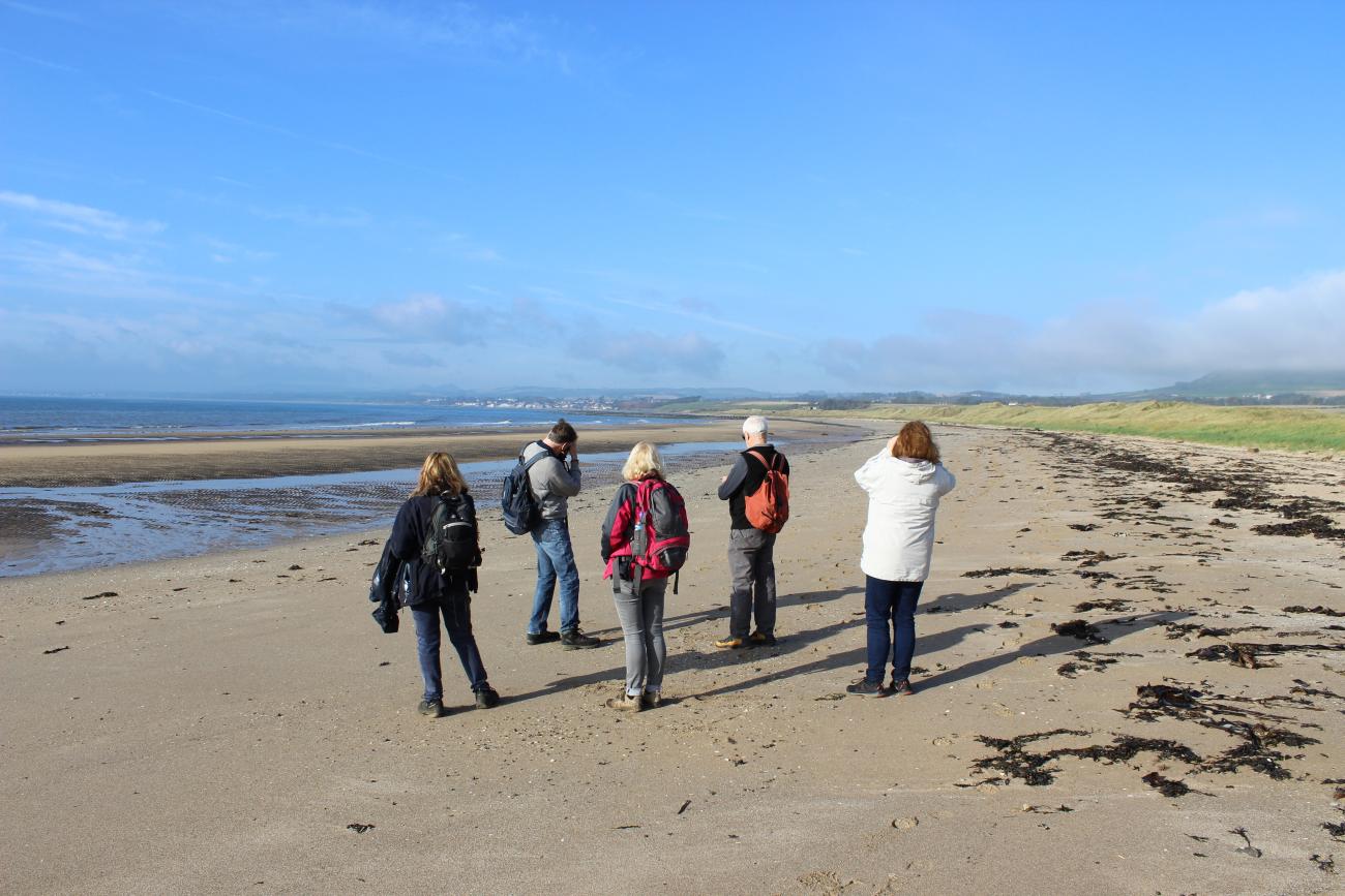 Walkers on the beach at Largo Bay