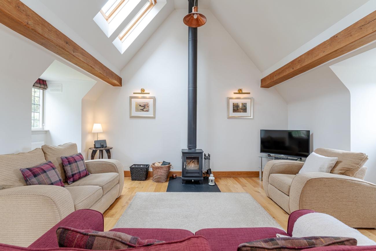 Baillie Scott - luxury open plan living with feature log fire