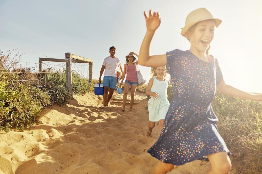 Family running on beach