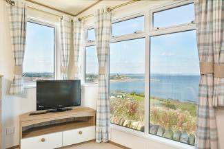 holiday home interior with lounge and sea view