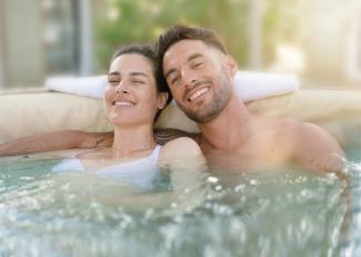 Young couple enjoying a hot tub