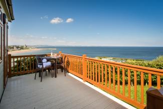 lodge with hot tub and sea views in dabbled sunlight