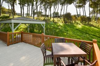 lodge with hot tub and sea views in dabbled sunlight