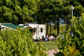 Couple relaxing outside their motorhome at St Andrews Holiday Park