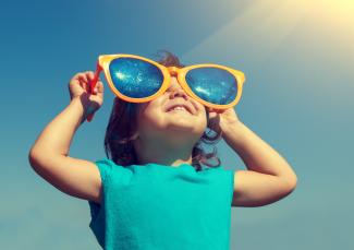 Happy girl wearing oversized sunglasses