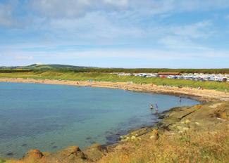 Families on the beach at Shell Bay, Elie Holiday Park on a summer's day