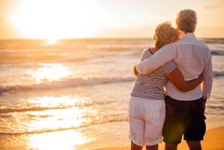 couple hugging on beach at sunset