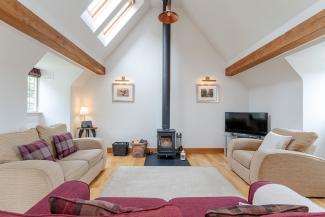 Baillie Scott - luxury open plan living with feature log fire