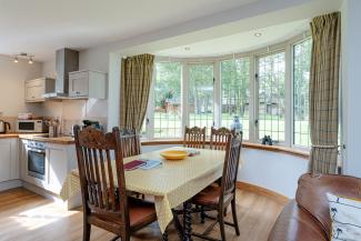 The Lady Bluebell - dining table set in a feature bay window