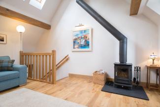 Valentines Cottage - high ceiling lounge with feature log fire